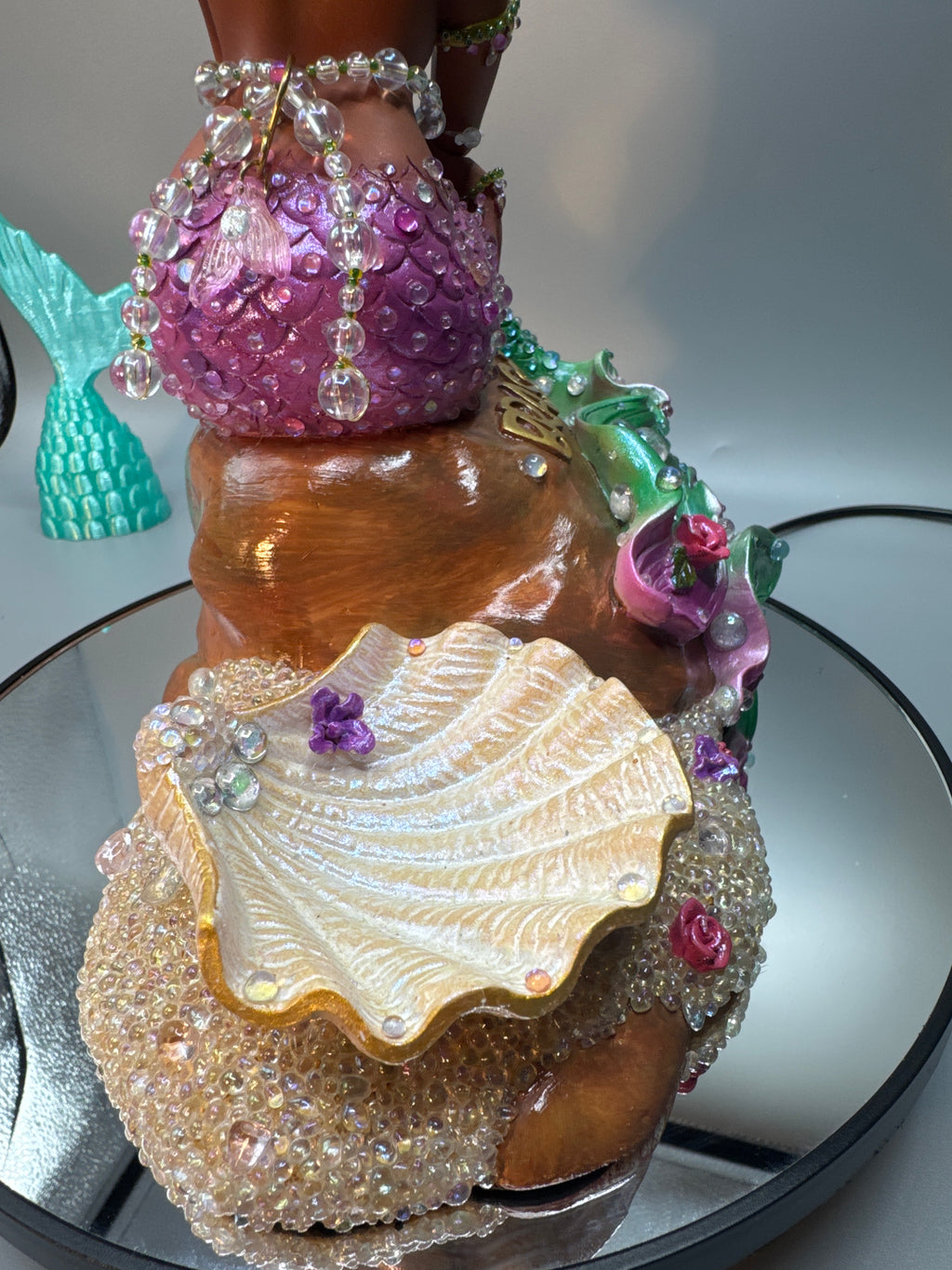 Detail shot of glowing bubbles and sparkling stones around Lumira’s base and Shell, giving the illusion of fresh-from-the-sea wetness. A magical Black mermaid statue from Enchanted Roots & Wonders.
