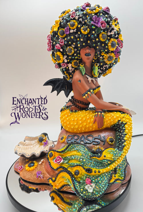 Lómara – a one-of-a-kind goth Black mermaid statue with vampire bat wings and sunflower-filled hair. Yellow and black tail, dark lipstick, and a hauntingly regal look. Custom handmade fantasy sculpture for collectors by Clover Jené Mermaid.