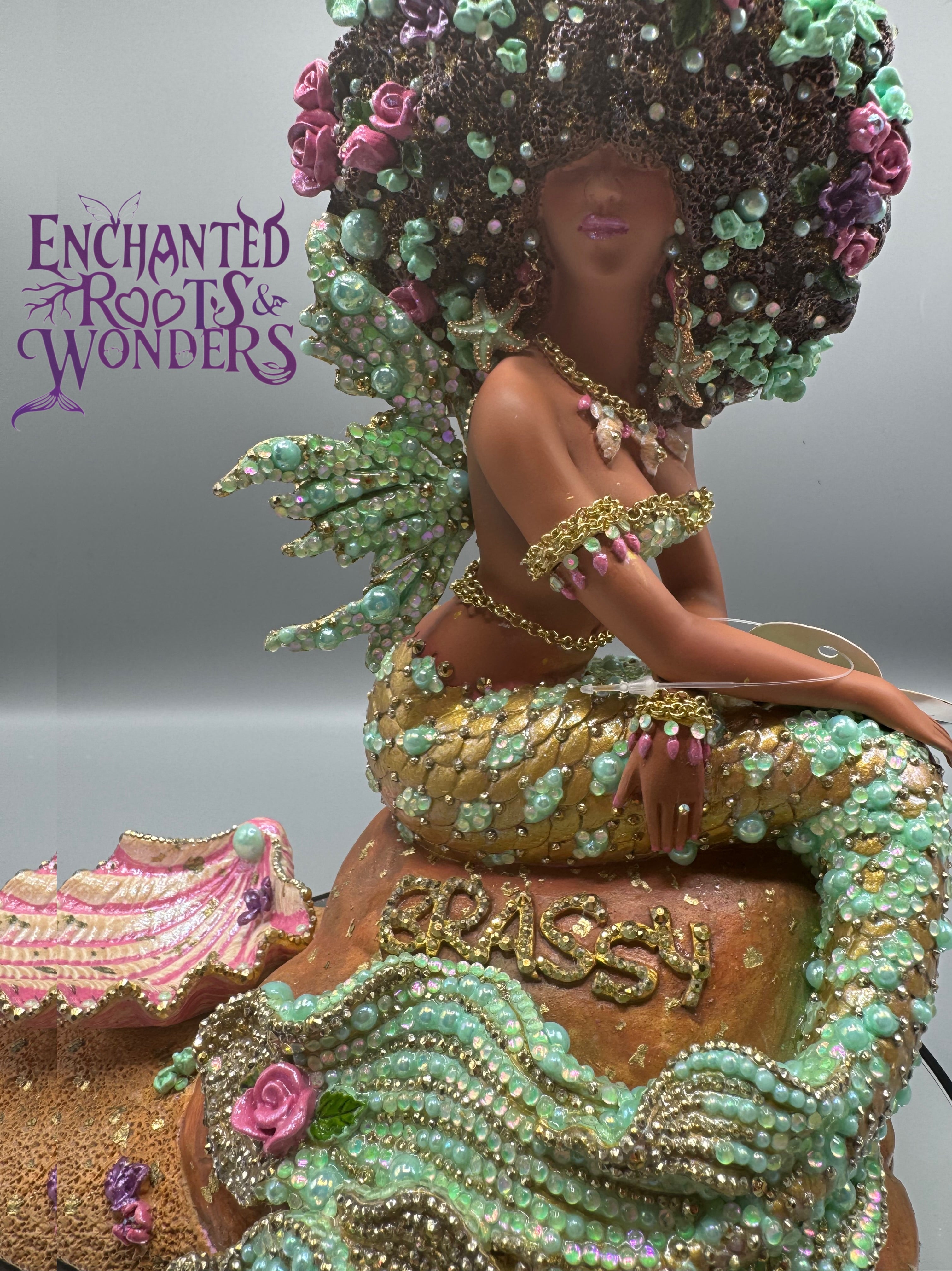 Nayanja – radiant seafoam green and blush pink mermaid fairy statue with gold accents. Encrusted with rhinestones, arm bands, fairy wings, and chains. Custom-created by artist Clover Jené Mermaid for her personal muse. Ethereal and divine.