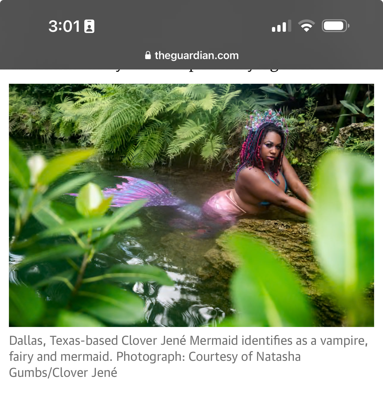 Clover Jené Mermaid, owner of Enchanted Roots & Wonders, posing as a Black mermaid in her signature fantasy form