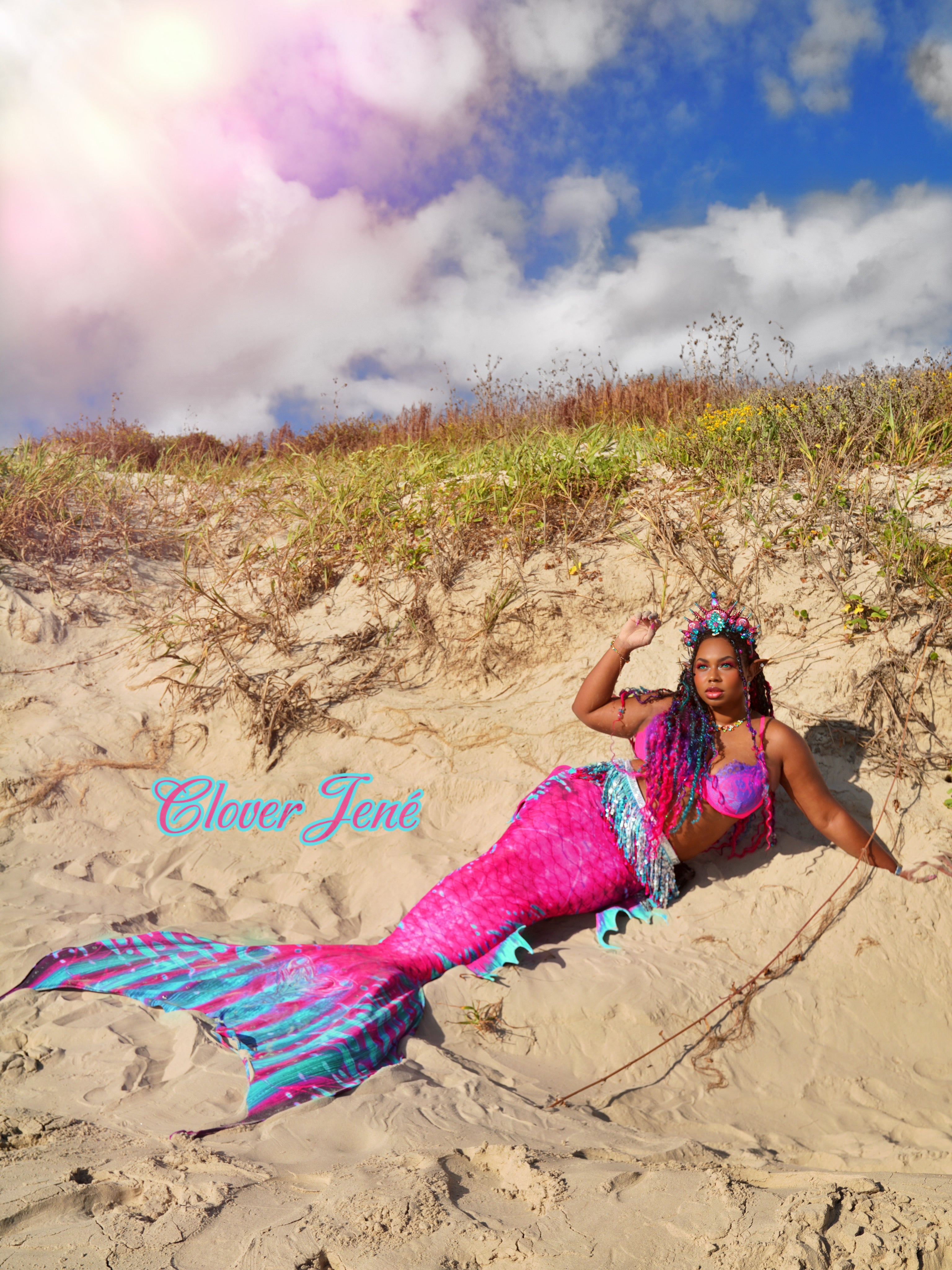 Clover Jené Mermaid, owner of Enchanted Roots & Wonders, posing as a Black mermaid in her signature mermaid tail and fantasy form