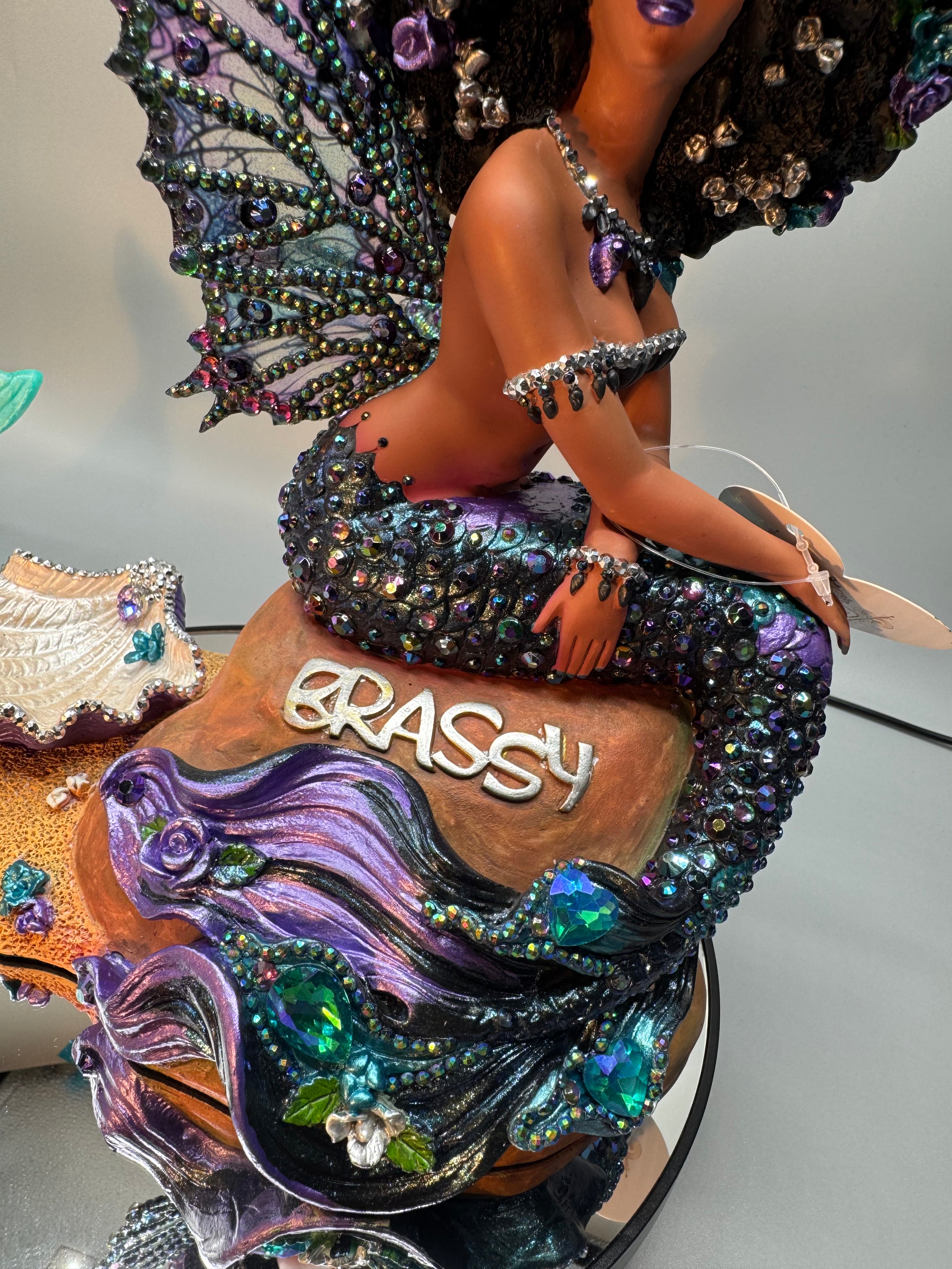 Detail of Oil Slick Brassy Black mermaid statue showing rhinestone tail, sculpted base, and Brassy signature